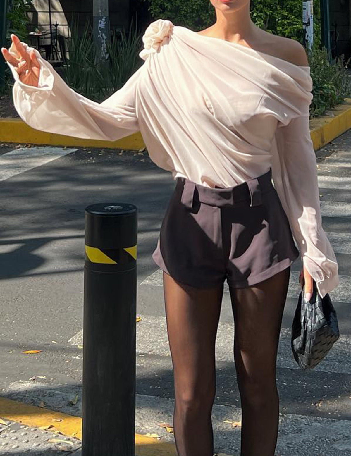 Blouse with draped fabric and floral detail, side profile