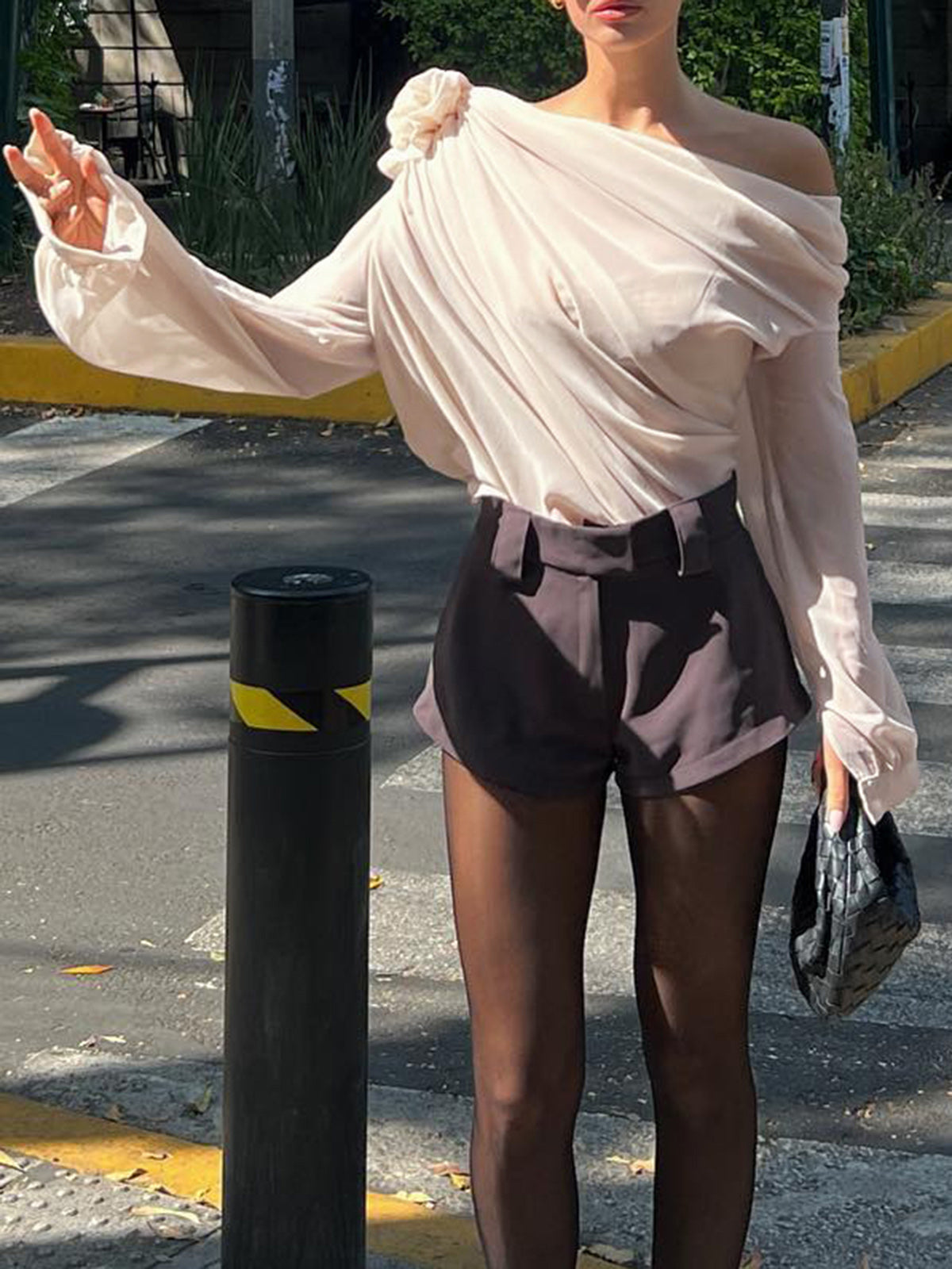 Blouse with draped fabric and floral detail, side profile