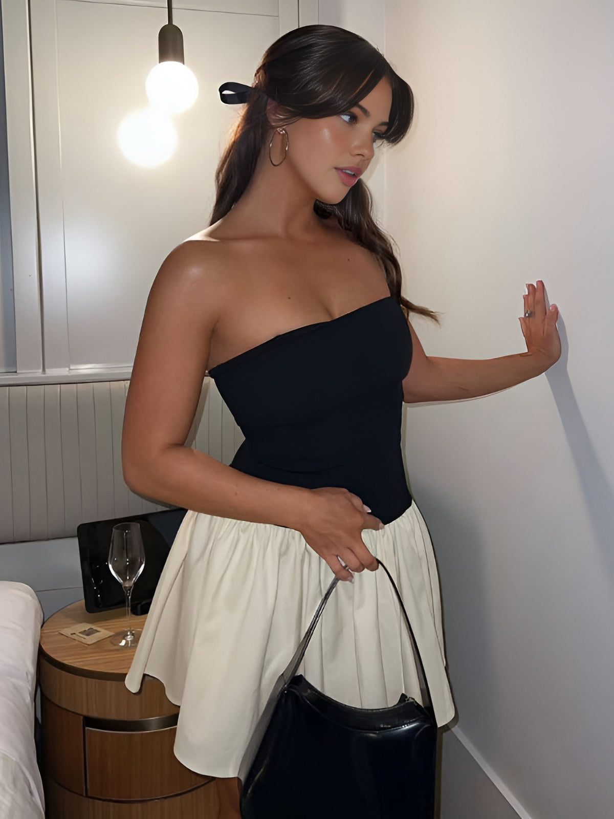 Strapless top with pleated skirt, black and white indoor setting
