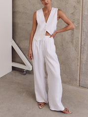 White linen set with wide-leg pants and buttoned top, side profile