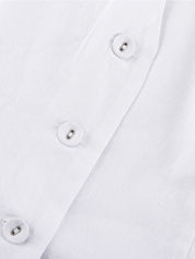 White linen buttoned top detail shot, showcasing fabric texture and buttons
