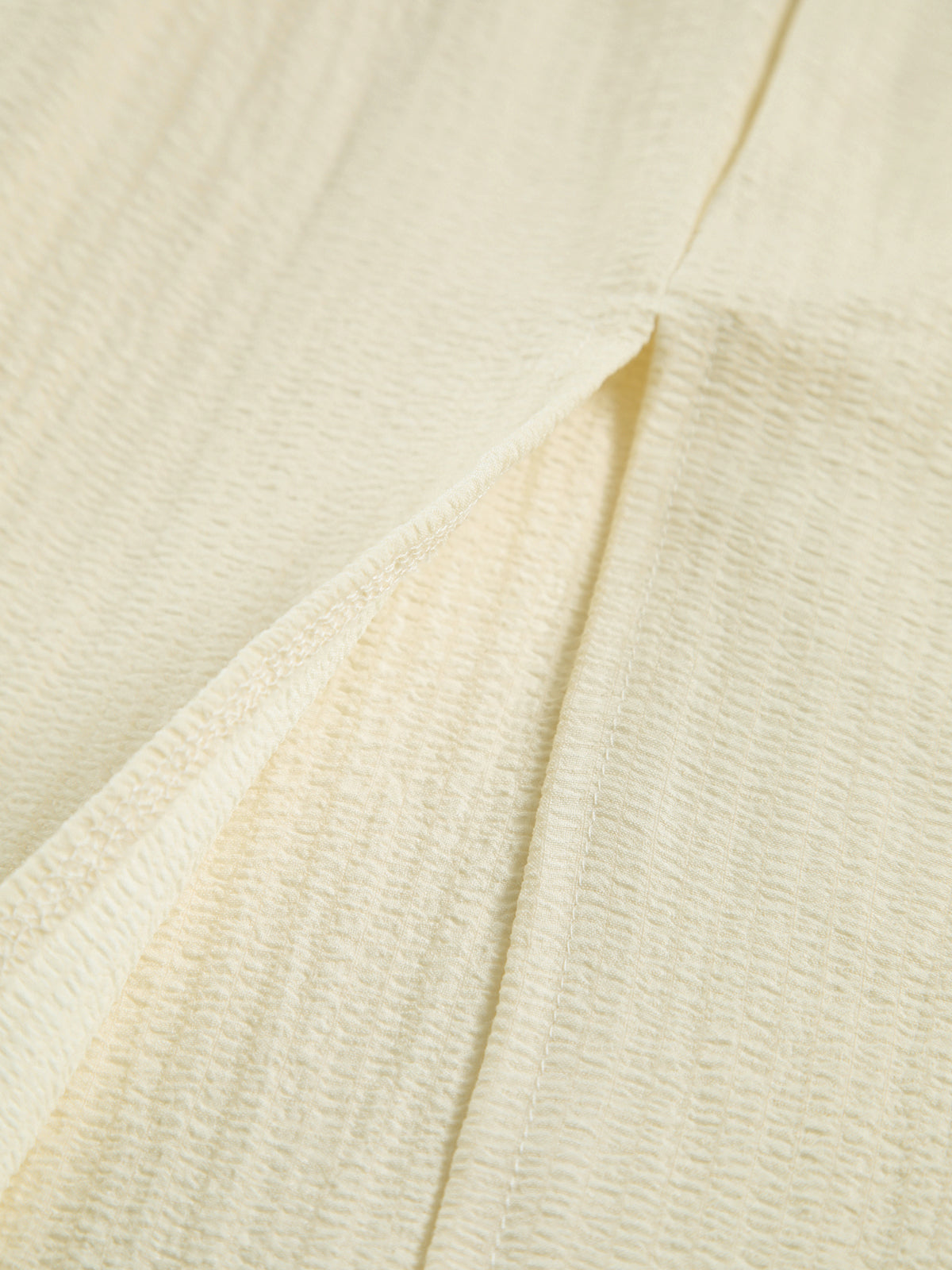 Cream dress side slit detail, textured fabric