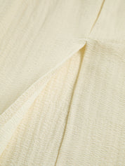 Cream dress side slit detail, textured fabric
