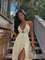 Cream maxi dress with front cutout and side slit, model wearing