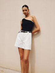 White high-waisted pleated shorts with black belt full body view