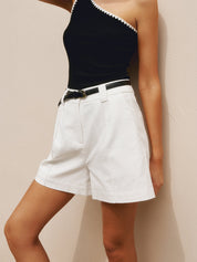 White high-waisted pleated shorts with black belt front view