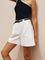 White high-waisted pleated shorts with black belt front view