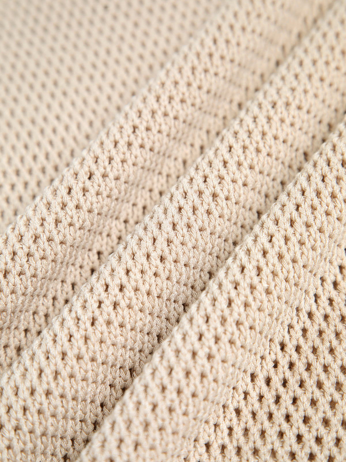 Beige sleeveless top with open texture close-up detail