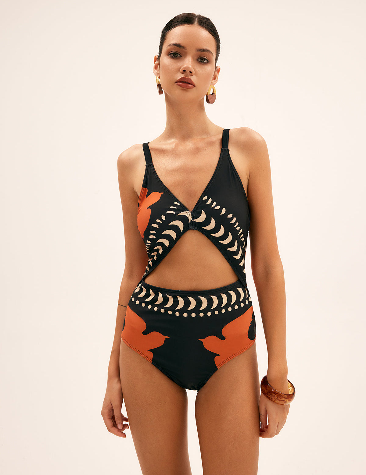One-piece swimsuit black with orange and white patterns, front profile view