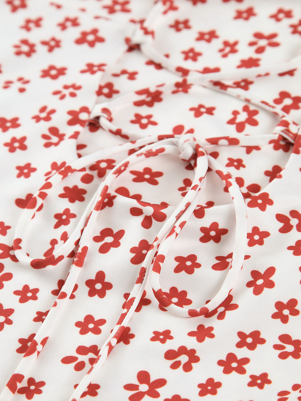 Maxi dress white with red floral pattern close-up of tie detail