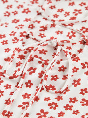 Maxi dress white with red floral pattern close-up of tie detail