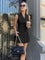 Black sleeveless blazer and pleated skirt set front view