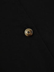 Close-up of black vest with brown buttons