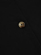 Close-up of black vest with brown buttons