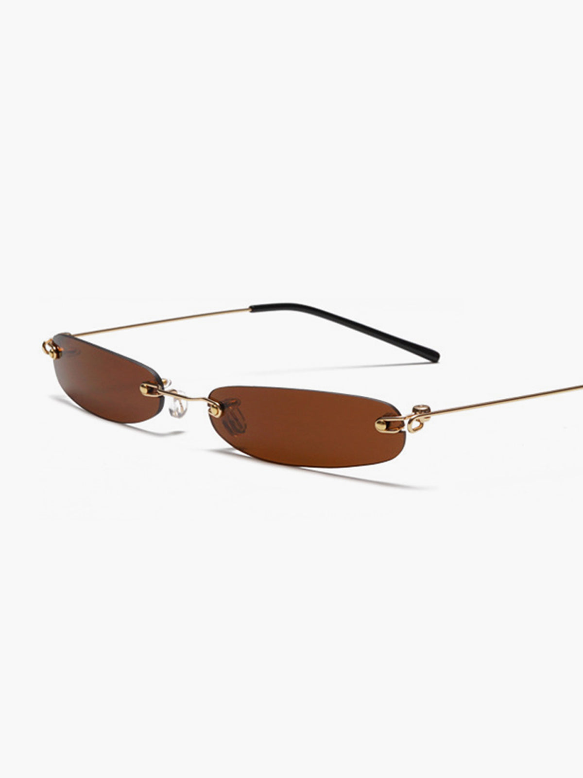 Sunglasses with brown lens and gold frame, angled front view