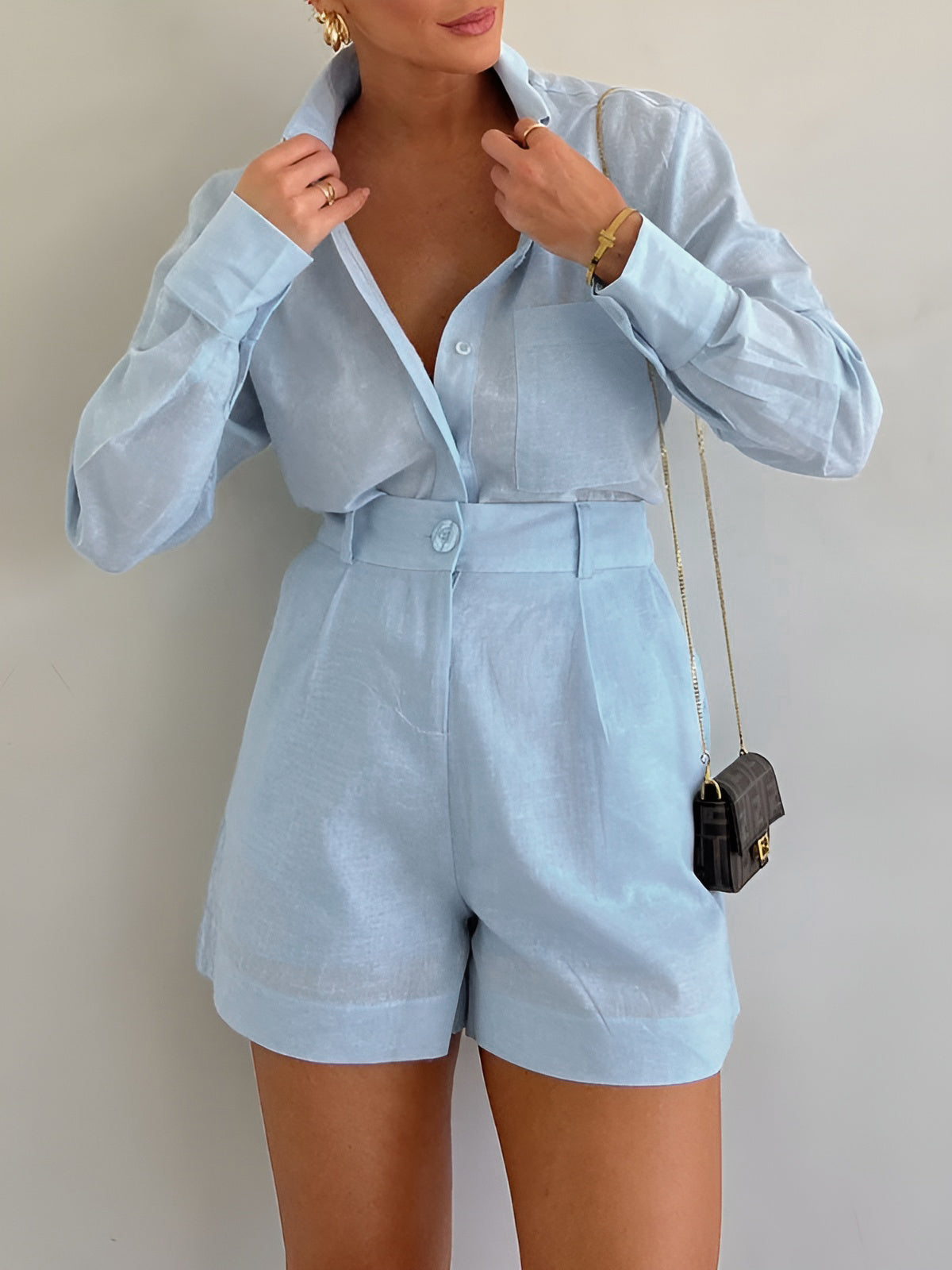 Light blue linen co-ord set front view with hands adjusting collar