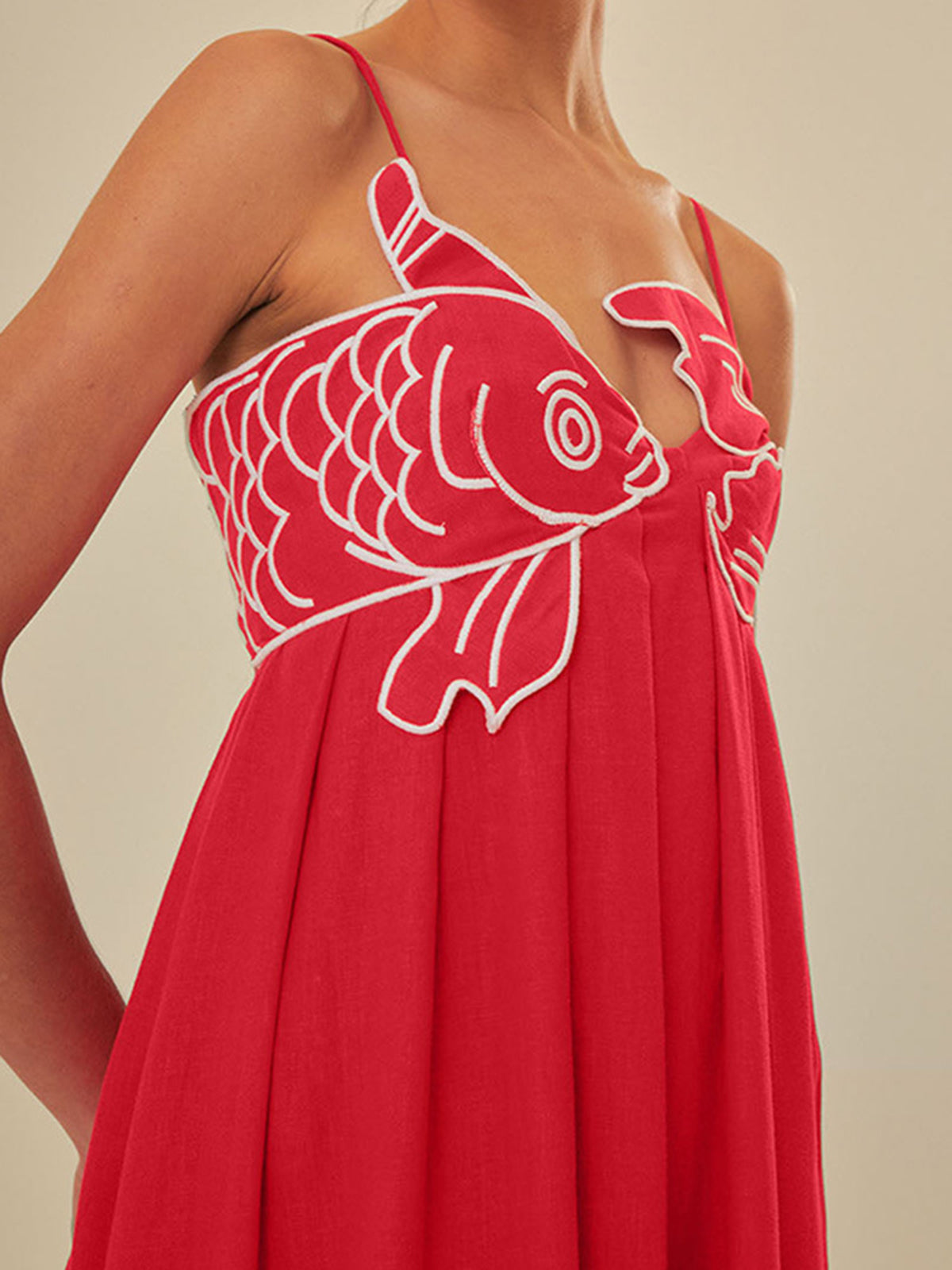 Red maxi dress with white fish embroidery close-up detail
