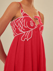Red maxi dress with white fish embroidery close-up detail