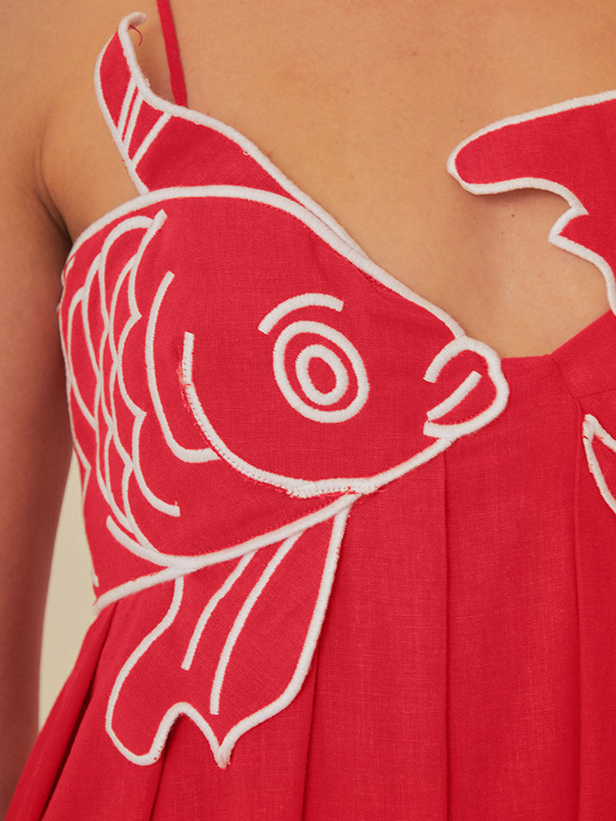 Red maxi dress with white fish embroidery close-up front detail