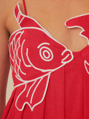 Red maxi dress with white fish embroidery close-up front detail