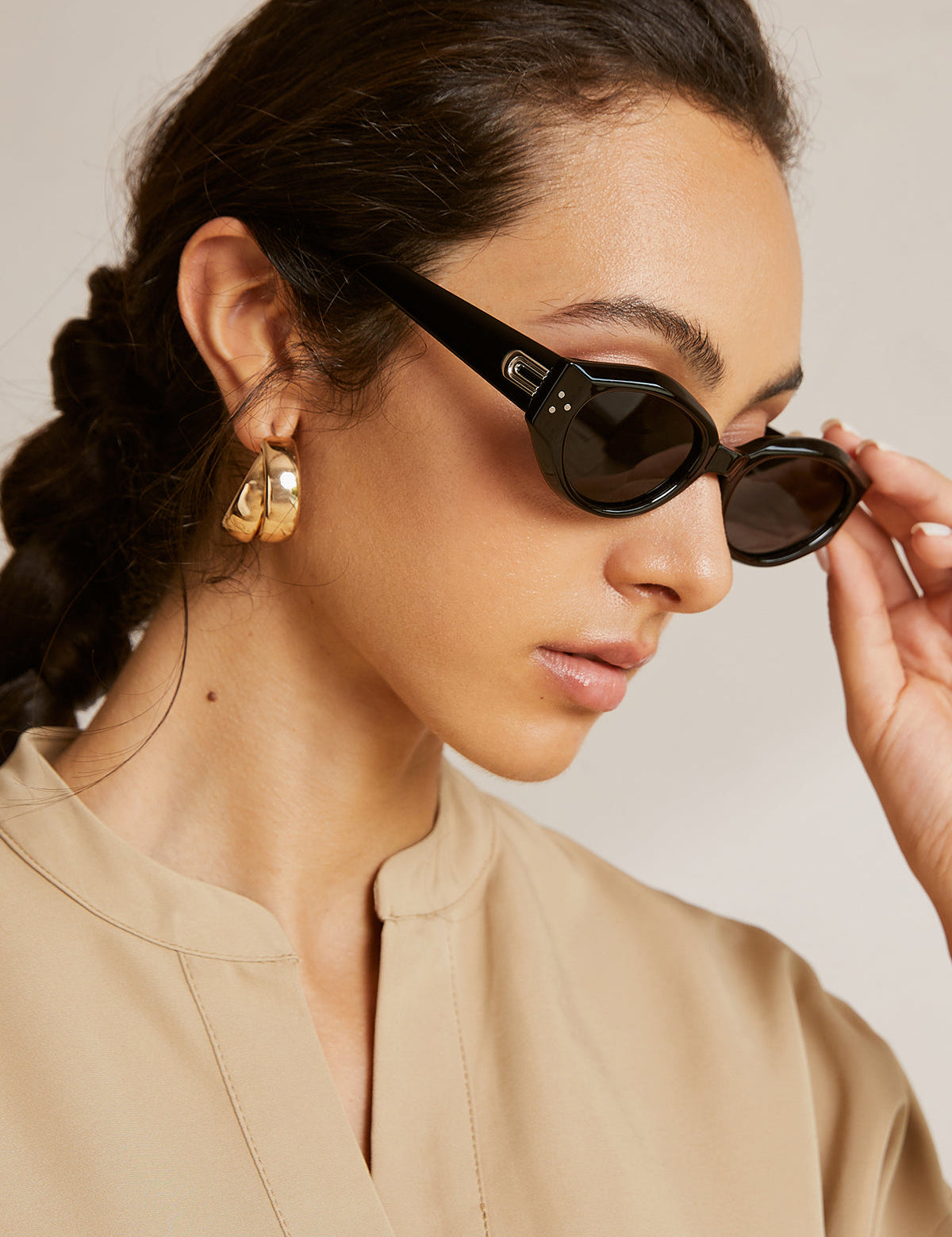 Cat-eye sunglasses with silver hardware worn by model, side view