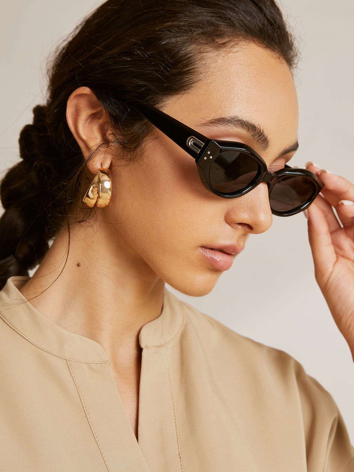 Cat-eye sunglasses with silver hardware worn by model, side view