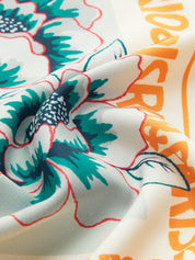 Detail of wrap skirt fabric with layered floral design and text