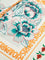 Close-up of floral print with bold orange text and green accents
