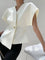 White V-neck top with gold button detail, side view with handbag