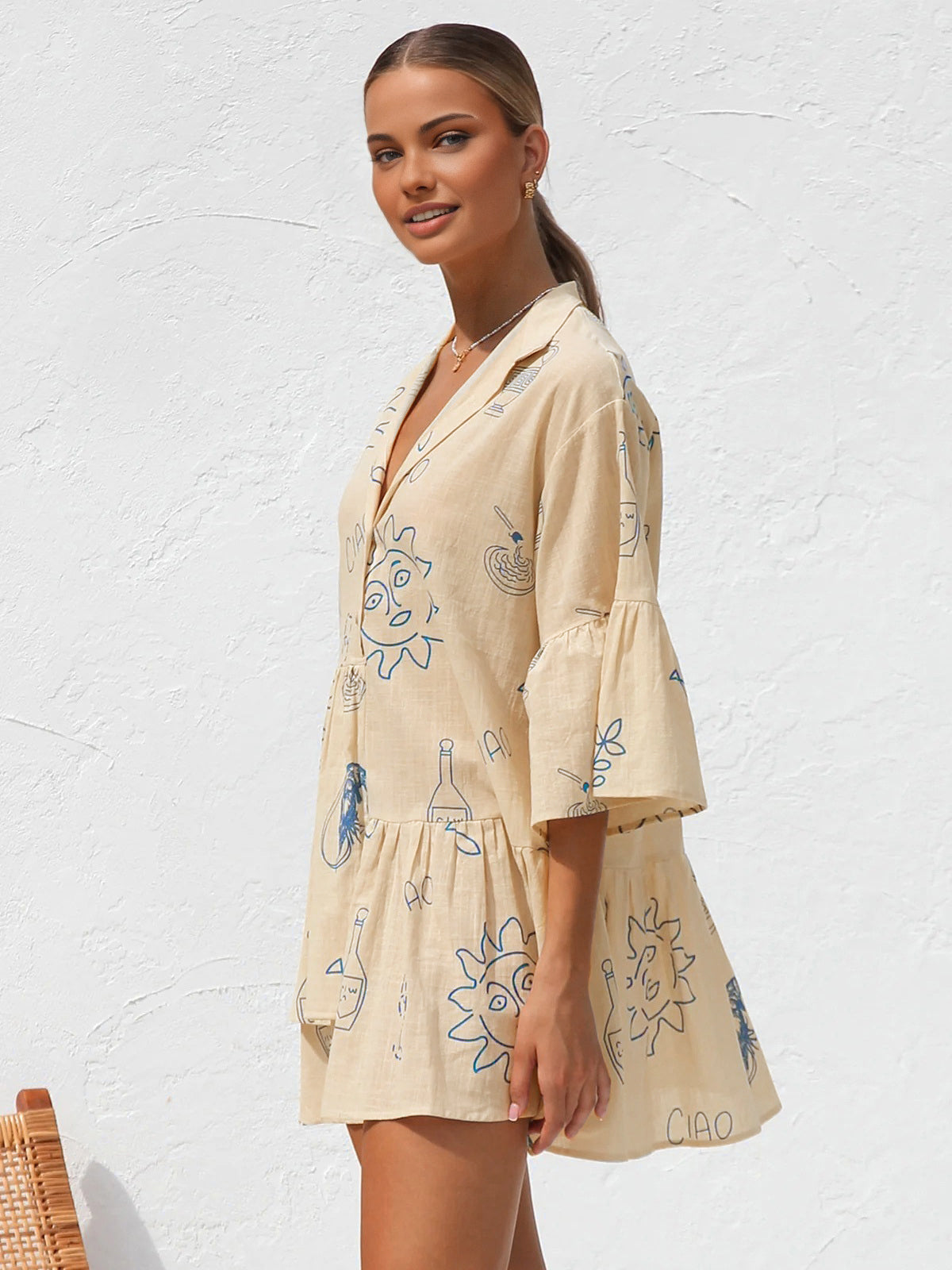 Summer dress with blue sun and bottle print three-quarter view