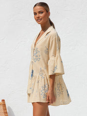 Summer dress with blue sun and bottle print three-quarter view