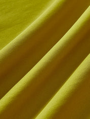 Green cocktail dress fabric texture, close-up