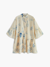 Summer dress with blue sun and bottle print flat lay