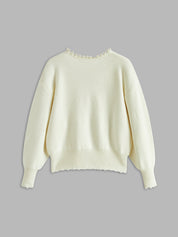 Cream cardigan with pearl embellishments flat lay back view