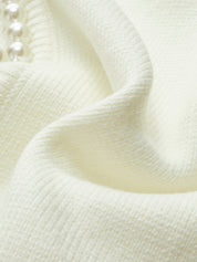 Cream cardigan hem detail close-up