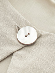 Maxi dress beige button detail close-up