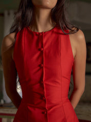 Red sleeveless dress buttons close-up detail