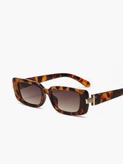 Brown tortoiseshell sunglasses with gold hinge detail, side view