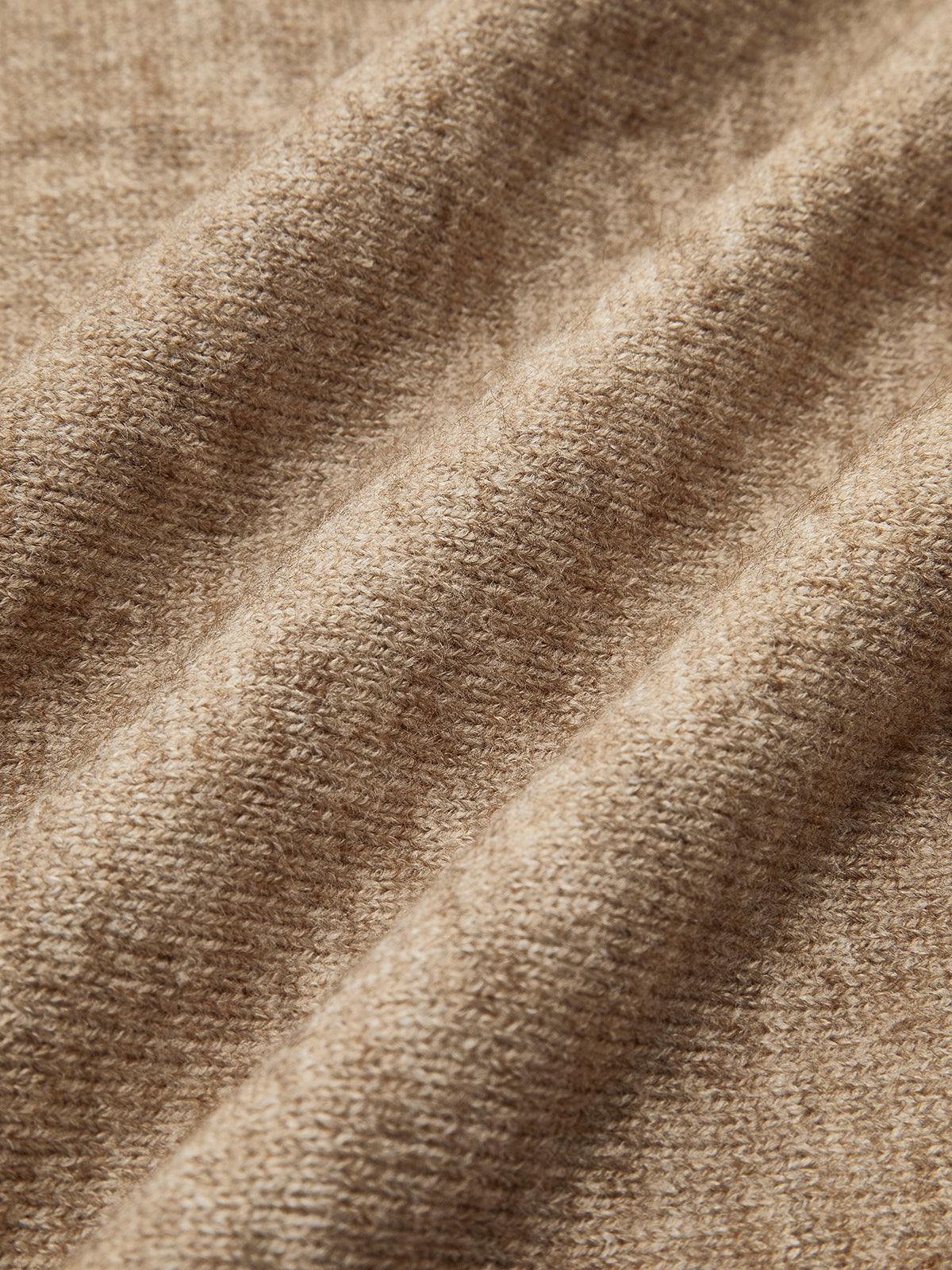 Beige knit sweater close-up of texture and knit pattern