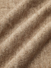 Beige knit sweater close-up of texture and knit pattern