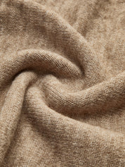 Beige knit sweater close-up of sleeve and turtleneck