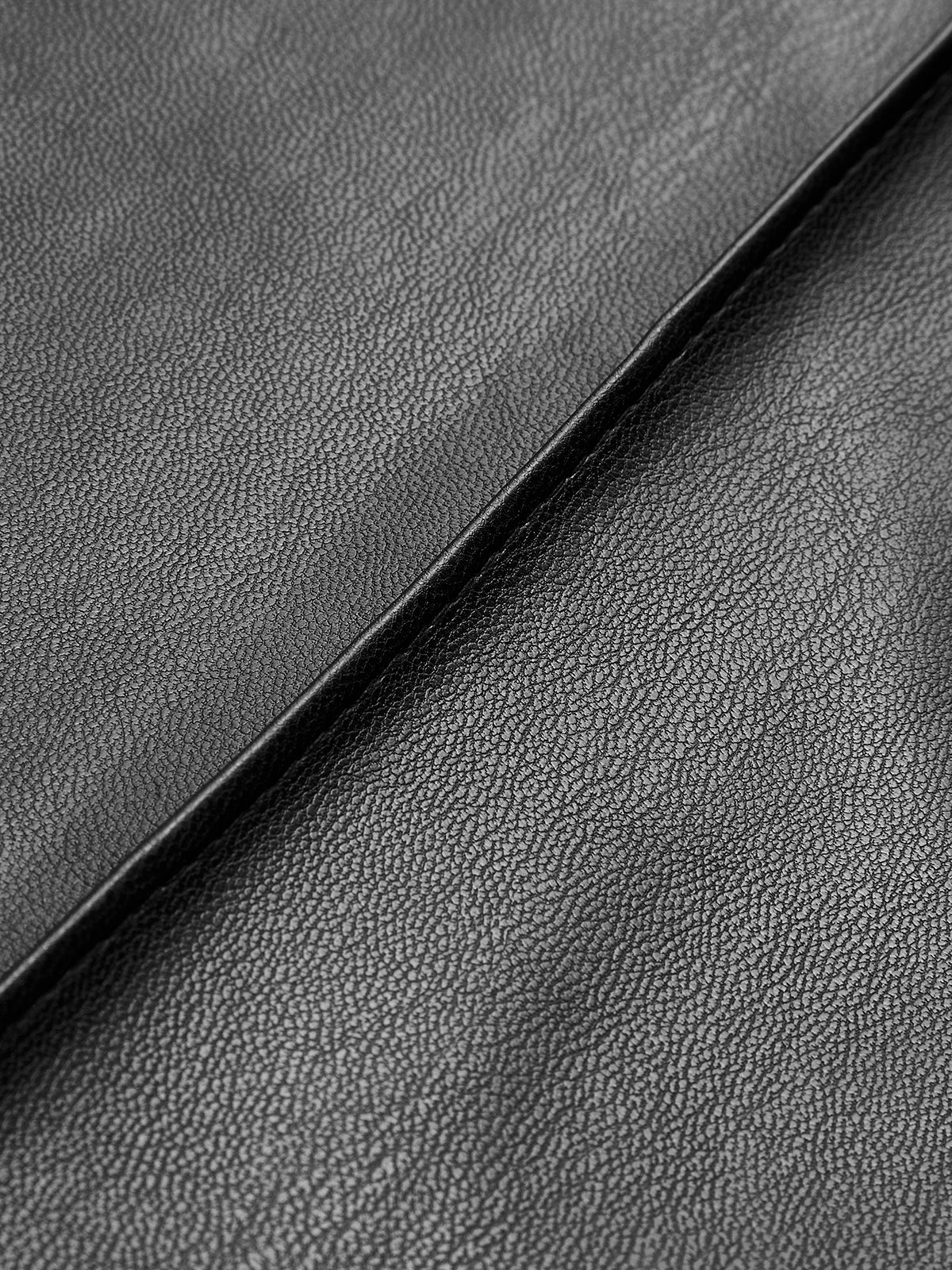 Close-up of black faux leather pants texture