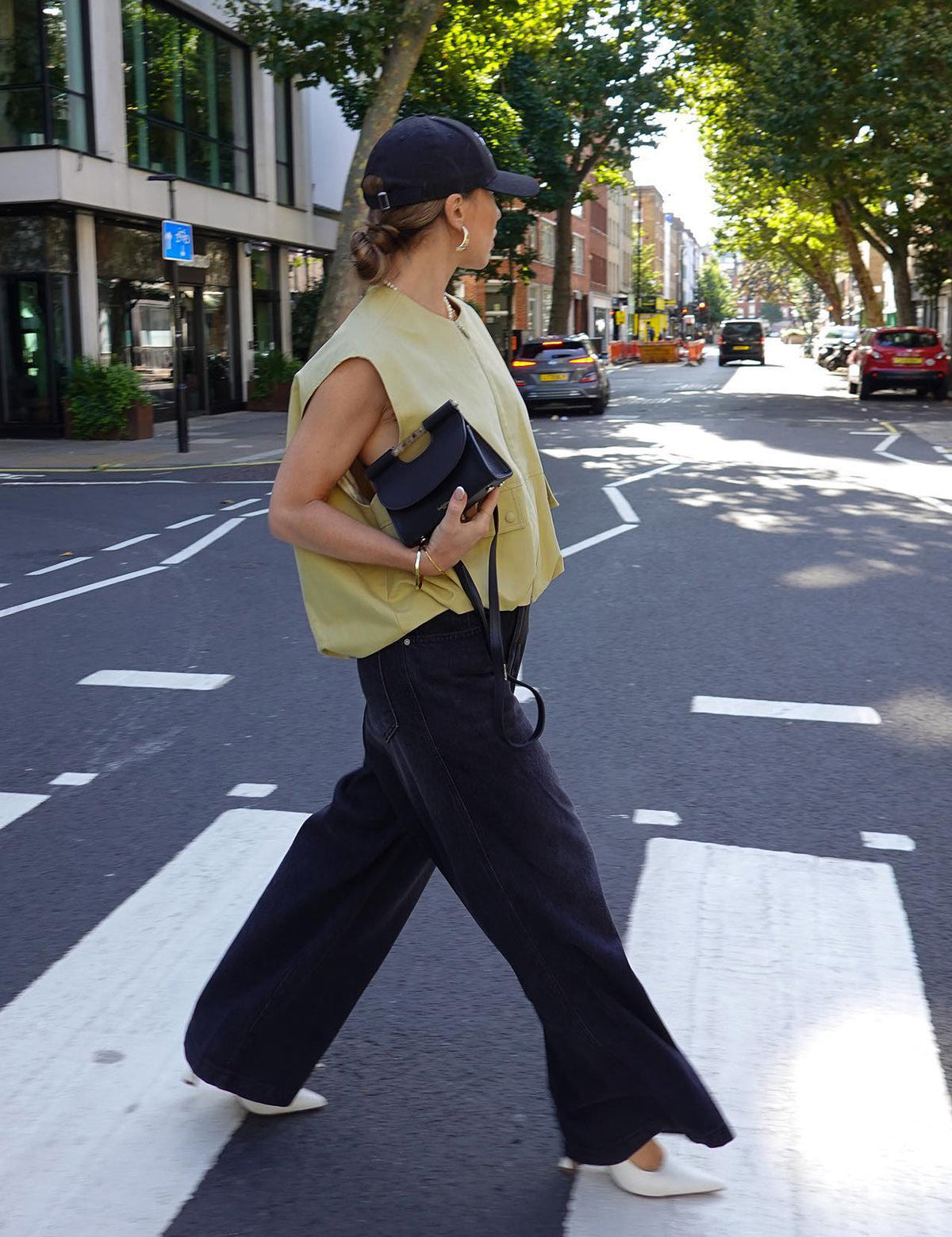 Yellow sleeveless vest with zipper and pockets side view