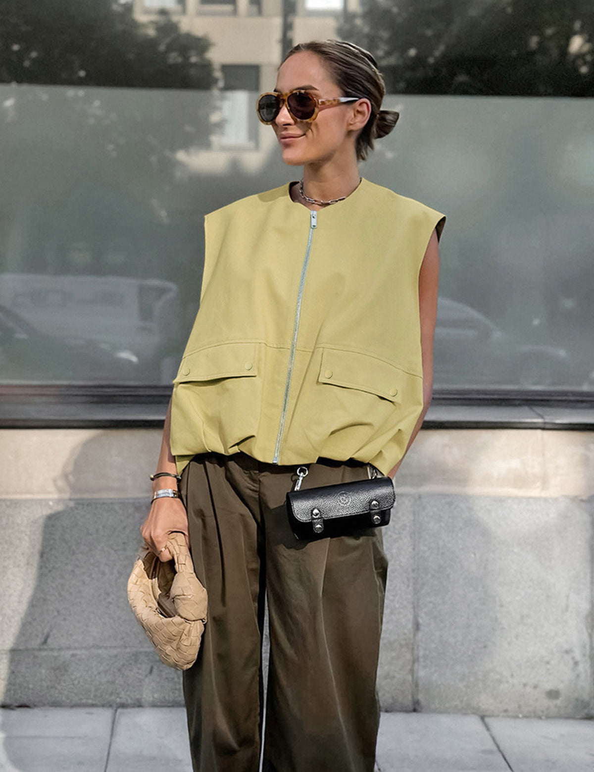 Yellow sleeveless vest with zipper and pockets front view