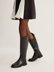 Black leather knee-high boots with zipper worn front view