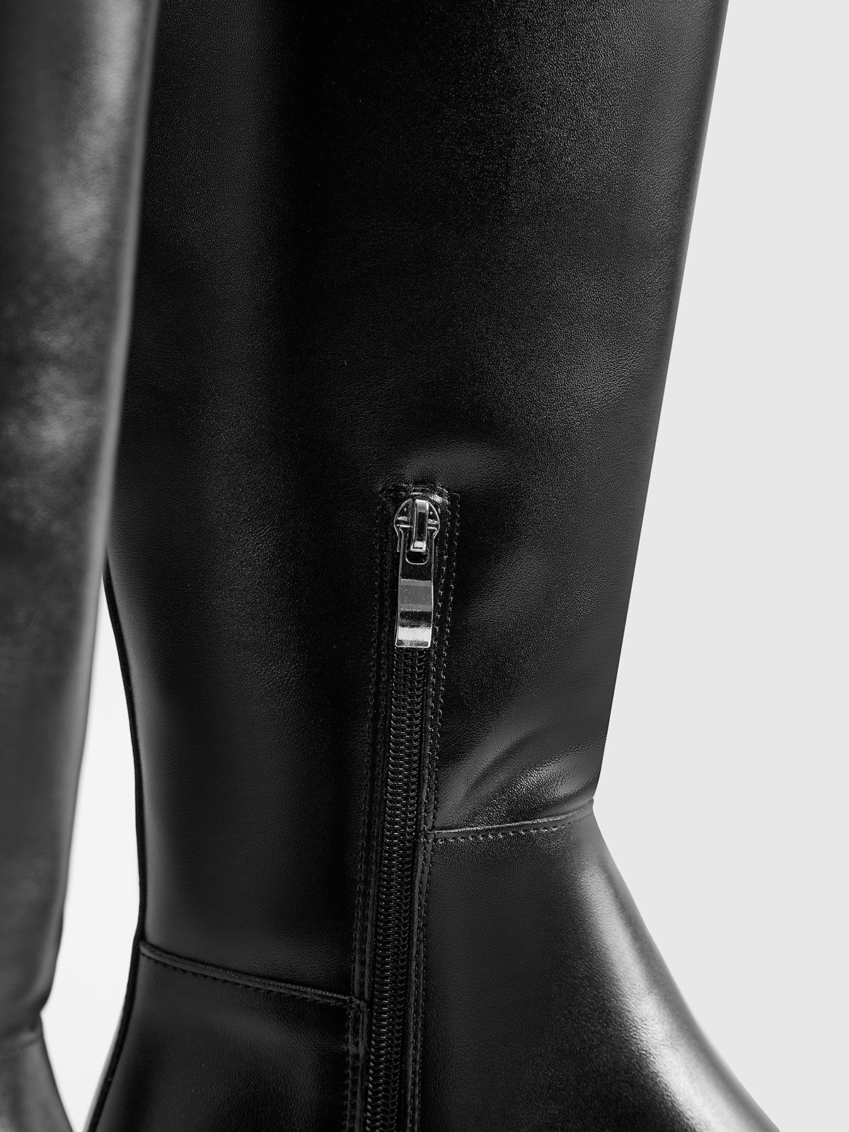 Black leather knee-high boots zipper detail