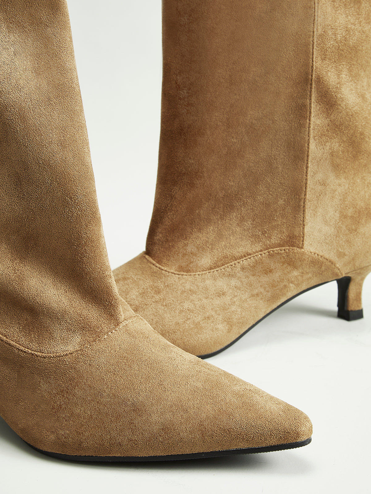 Brown suede knee-high boots close-up detail