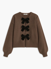 Cardigan brown with black velvet bows front view plain background