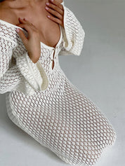 Close-up of white crochet dress with bell sleeves and button detail