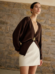 Brown cardigan with gold button three-quarter view